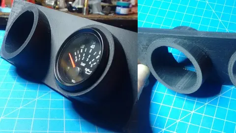3D-printed dual gauge pod holding one 52 mm gauge, angled toward the driver