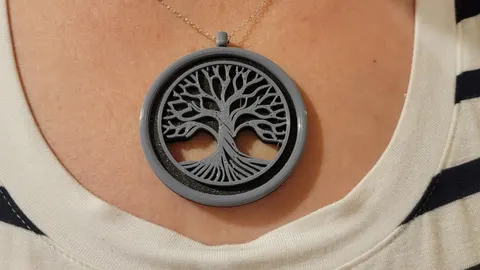 3D-printed round Tree of Life pendant worn on a chain