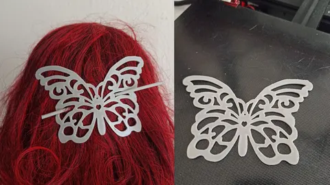 White 3D-printed butterfly hair slide worn in red hair, and the butterfly on a print bed